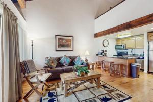 a living room with a couch and a table at Beautiful Condo with private beach access & shared pools in South Lake Tahoe