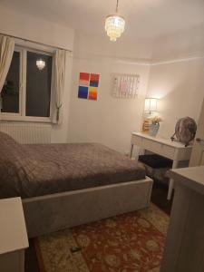 a bedroom with a bed and a table and a window at Double rooms in shared house in Bournemouth
