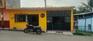 a motorcycle parked in front of a yellow building at Pilatos in Ocosingo