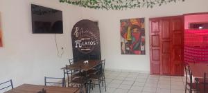 a room with tables and a surfboard on the wall at Pilatos in Ocosingo