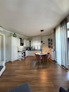 a kitchen and living room with a table and chairs at 5 min from the center, Elevator , 4 guests, 2 bedrooms in Turin