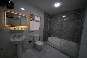 a bathroom with a sink and a toilet and a shower at Triple garden view hotel in Cairo +120 photos