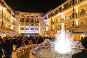 a fountain in front of a building with a crowd of people at Appartamento Doglio Lux in Cagliari