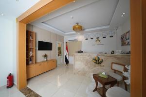 a living room with a counter and a table in a room at Triple garden view hotel in Cairo
