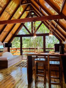 a large room with a bar in a cabin at Cabanas do Bosque in Três Coroas