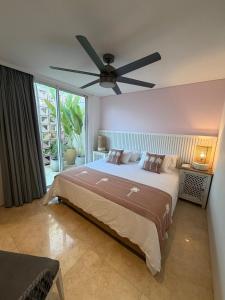 a bedroom with a large bed with a ceiling fan at Sol del Este Luxury by SH in San Andrés +38 photos
