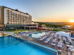 a view of a hotel with a pool and a resort at Movenpick Resort and Spa Fruske Terme in Vrdnik