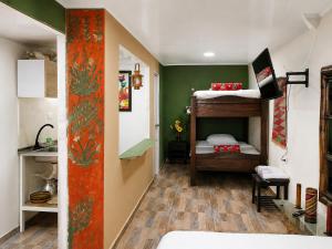 a room with two bunk beds and a kitchen at Central Apartment Salento Colombia in Salento