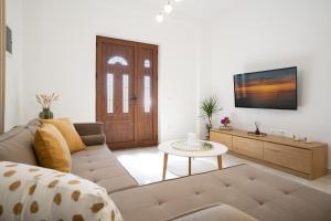 a living room with a couch and a table at Oasis White Terra in Durrës