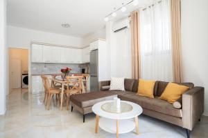 a living room with a couch and a table at Oasis White Terra in Durrës