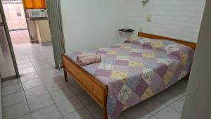 a bedroom with a bed with a quilt on it at Alto Unimev II in Guaymallen