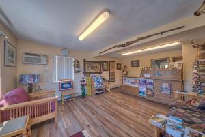 a living room with a couch and wooden floors at A Western Rose in Cody