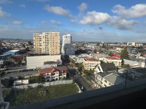 a view of a city with tall buildings in the background at Alto Arrayán II in Osorno
