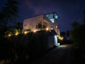 a house with lights on the side of it at night at MSM Diamond Villa in Wattala +8 photos