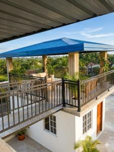 a balcony with a blue umbrella on top of a house at MSM Diamond Villa in Wattala
