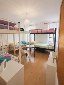 a room with three bunk beds and a table at Guest House Emilio 1 in Split