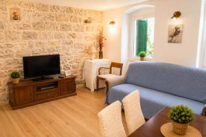 a living room with a couch and a tv at Guest House Emilio 1 in Split