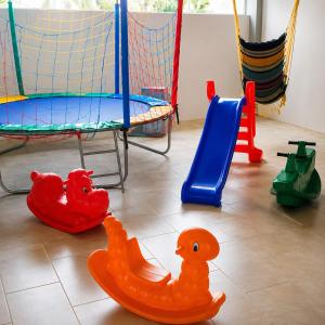 a room with various childrens toys on the floor at Pousada Vó Santina in Protásio Alves