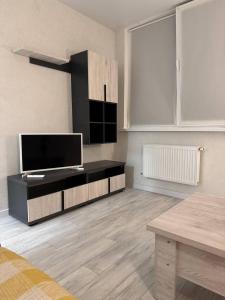 a living room with a flat screen tv on the wall at Modern & Quiet Apartment in Chişinău