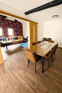 a dining room with a table and chairs and a bedroom at とっくりhouse in Takashima