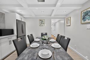 a dining room with a table and chairs at Modern and spacious 3-BR basement suite in Vancouver