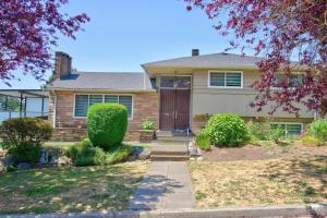 a brick house with a brown door at Modern and spacious 3-BR basement suite in Vancouver