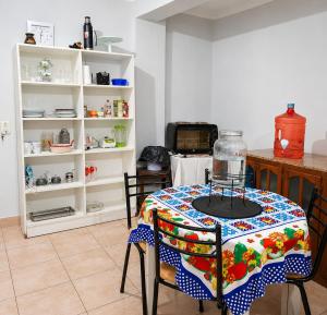 a kitchen with a table and chairs in a room at Depto rep del libano 11 capacidad 5 personas in La Banda