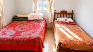 a bedroom with two beds and a window at Depto rep del libano 11 capacidad 5 personas in La Banda
