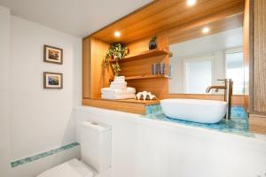 a bathroom with a white tub and a sink at Green Scape - Whale Beach in Whale Beach +10 photos