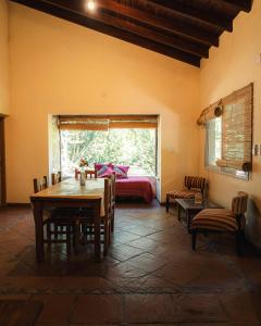 a room with a table and a bed and a window at Canto a Jujuy - Yala in Yala