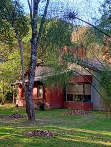 a red house with a tree in front of it at Canto a Jujuy - Yala in Yala