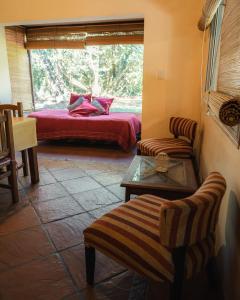 a room with a bed and a couch and a table at Canto a Jujuy - Yala in Yala