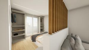 a living room with a couch and a window at EMERALD Suites Cervia in Cervia