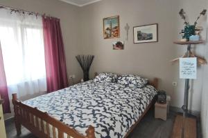 a bedroom with a bed with a blue and white comforter at Seaside secluded apartments Cove Skozanje, Hvar - 14899 in Gdinj