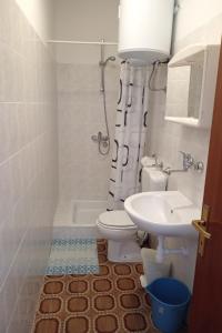 a bathroom with a toilet and a sink at Apartments by the sea Grscica, Korcula - 4487 in Prizba +18 photos