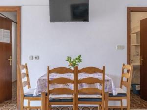 a table and chairs with a plant on top of it at Apartments by the sea Grscica, Korcula - 4487 in Prizba