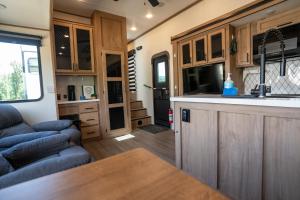 a kitchen and living room of an rv at Ouachita Outpost RV Park in Hodgen +18 photos