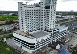 an overhead view of a tall white building at SF Roomstay Tunjong in Kota Bharu