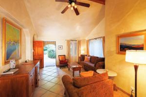 a living room with a couch and a ceiling fan at The Emerald Iguana Inn in Ojai