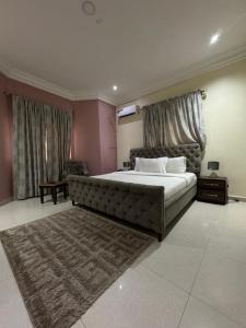 a bedroom with a large bed in a room at Zamin Suites in Kano