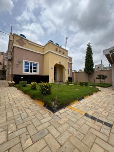 a house with a driveway in front of it at Zamin Suites in Kano