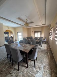 a conference room with a wooden table and chairs at Zamin Suites in Kano
