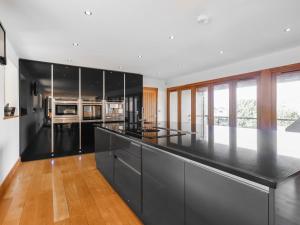 a kitchen with black cabinets and a counter top at High View House in Kemeys Inferior