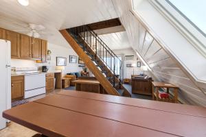 a kitchen with a wooden table and a staircase at Chalet #20 in Stevensville +40 photos