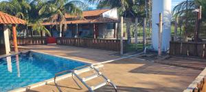a swimming pool in front of a house at Hotel E Pousada do Patrão in Bataguaçu +12 photos
