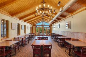 a dining room with tables and chairs and a chandelier at Tombstone Lookout Lodge, SureStay Collection by Best Western in Tombstone