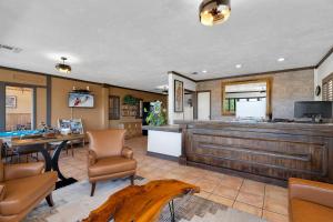 a lobby with a bar and a table and chairs at Tombstone Lookout Lodge, SureStay Collection by Best Western in Tombstone