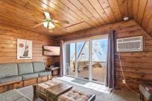 a living room with a couch and a ceiling fan at Chalet #18 in Stevensville