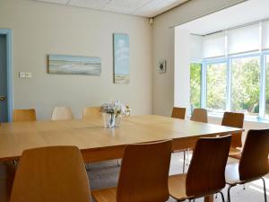 a conference room with a large wooden table and chairs at Field House in Baschurch +15 photos