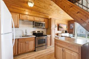 a kitchen with wooden cabinets and a stove at Chalet #16 in Stevensville
